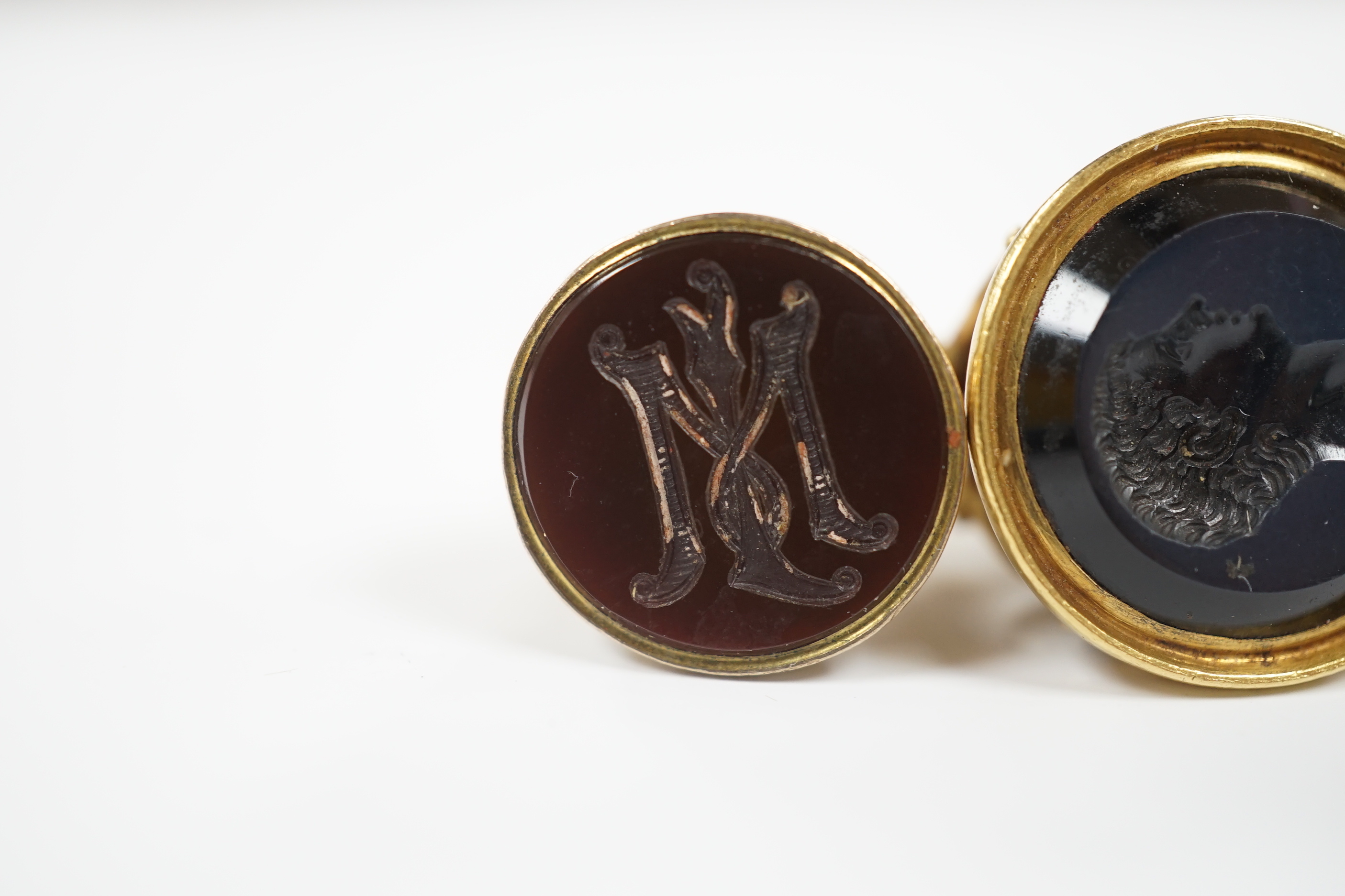 Three assorted Victorian and later yellow metal overlaid and chalcedony set fob deals, including intaglio bust of a gentleman, largest 35mm.